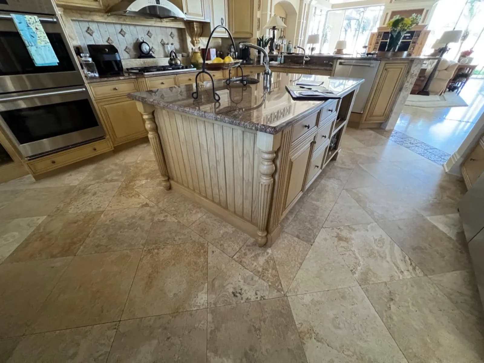Honey-toned kitchen island and cabinets before refinishing
