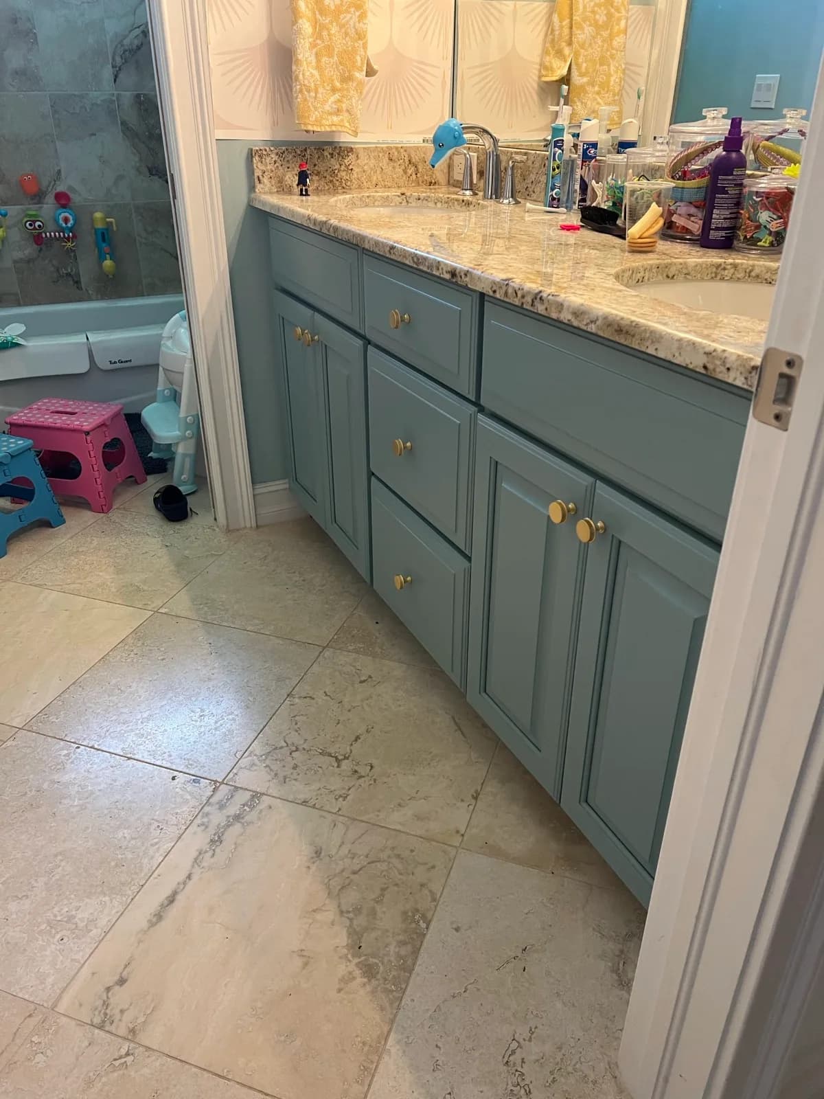 Bathroom vanity after refinishing in a soft blue-green
