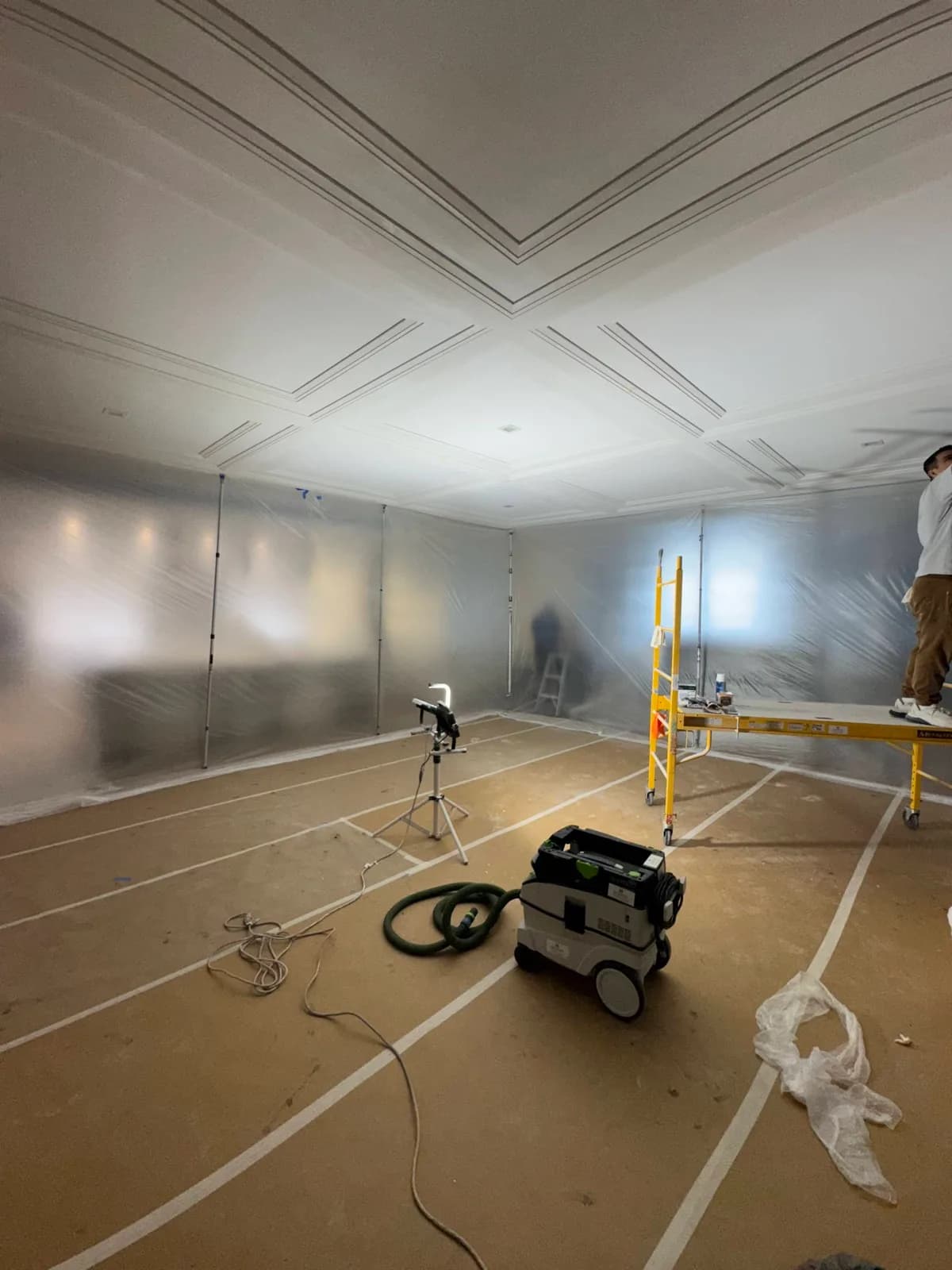 Room fully masked and sheeted before spraying starts