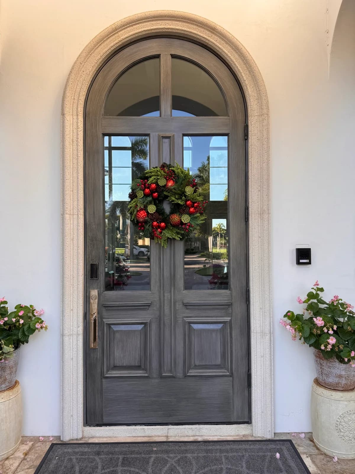 Refinished entry door framed by planted colour