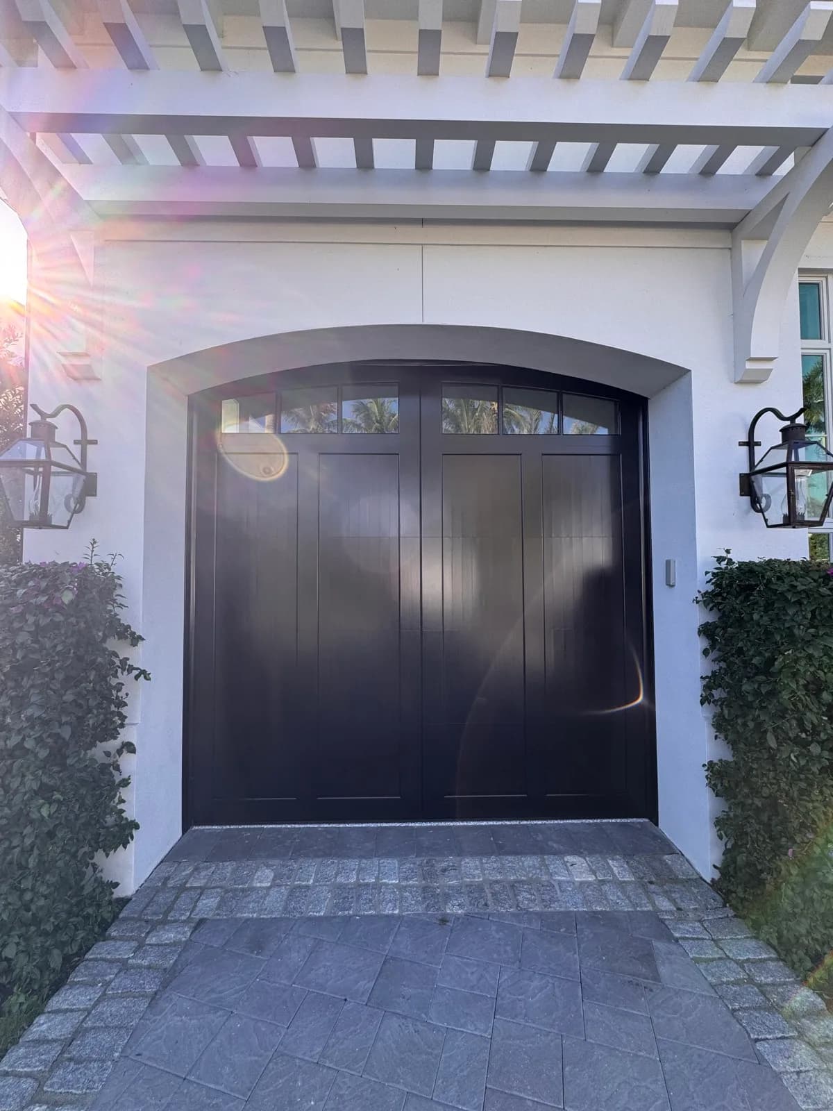 Arched garage door refinished in near-black