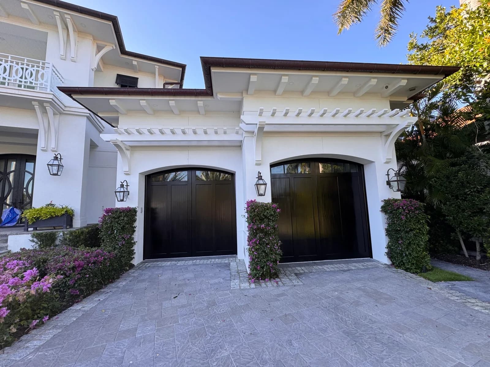 Matched pair of refinished garage doors on a white elevation