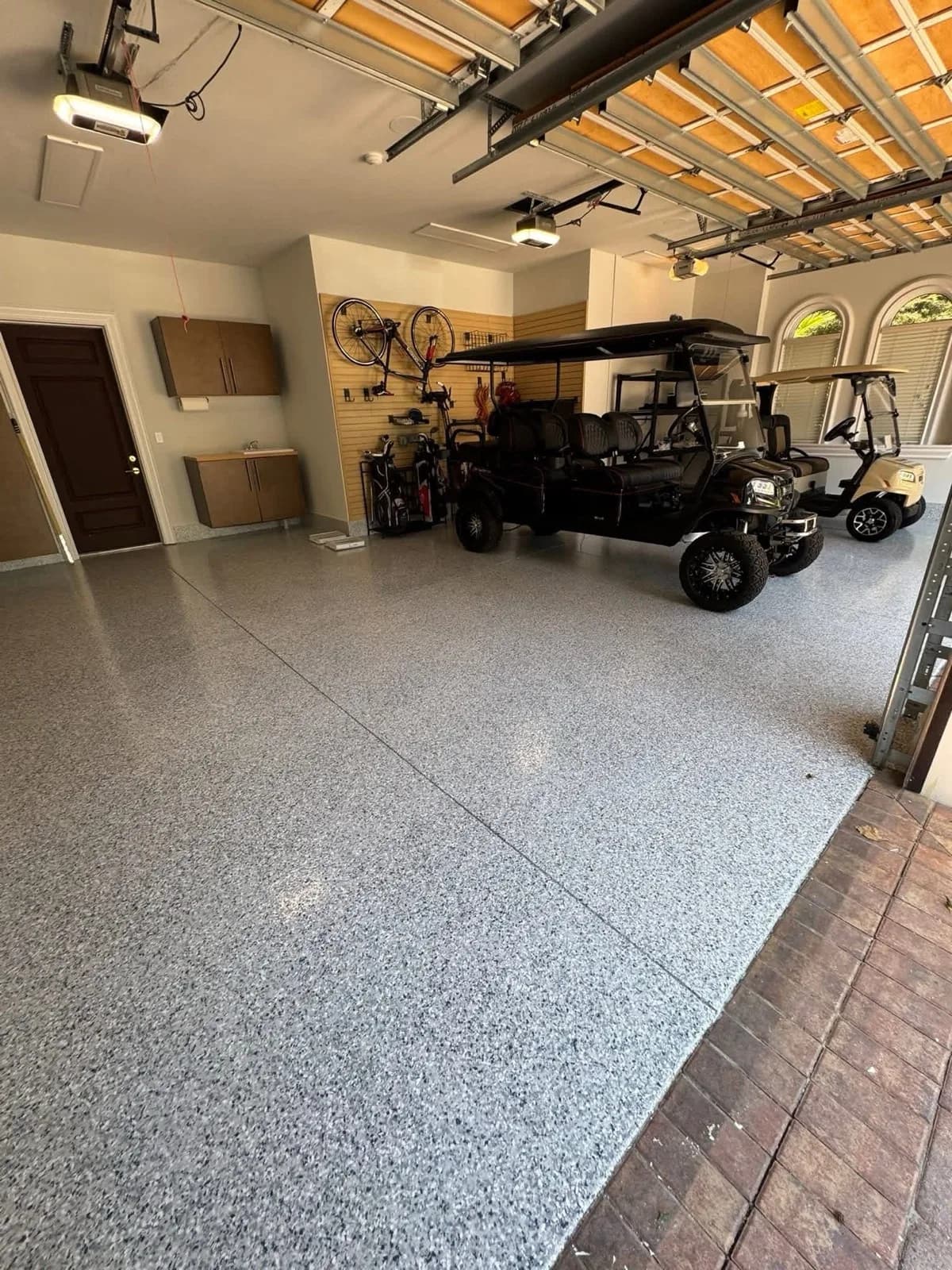 Finished flake epoxy floor in a garage with golf carts