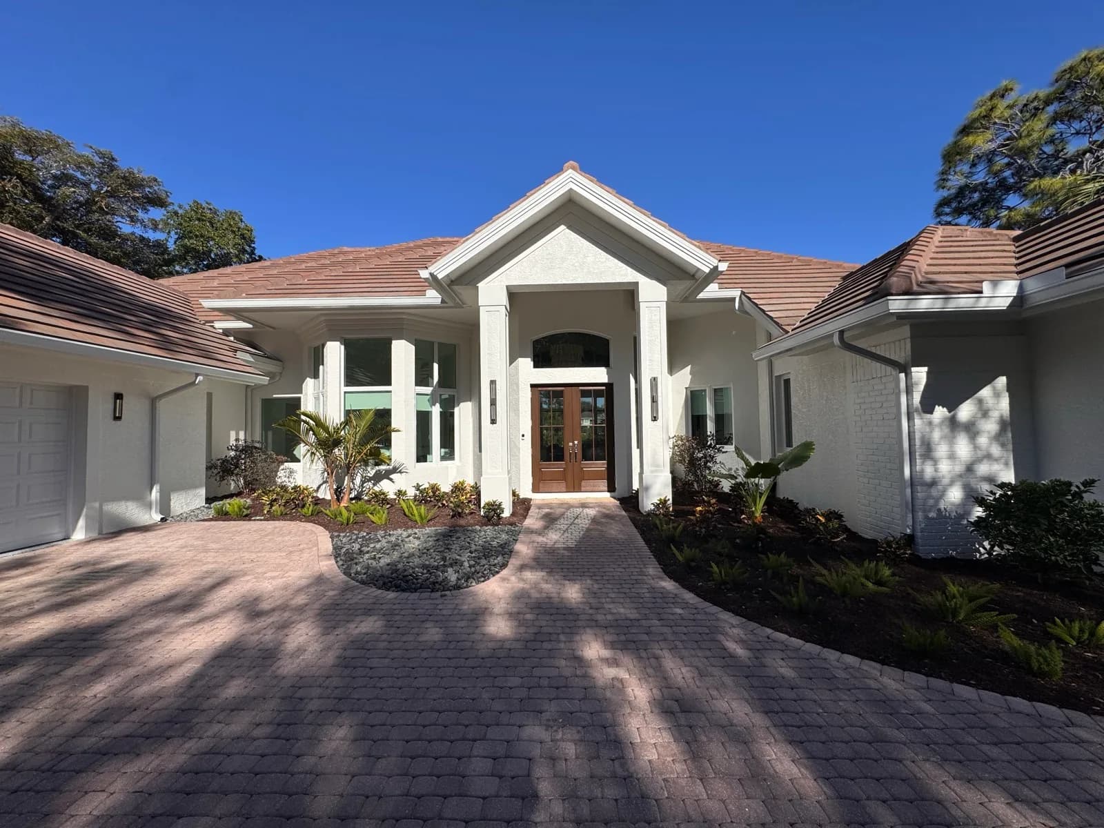 White home with a repainted entry and tile roof