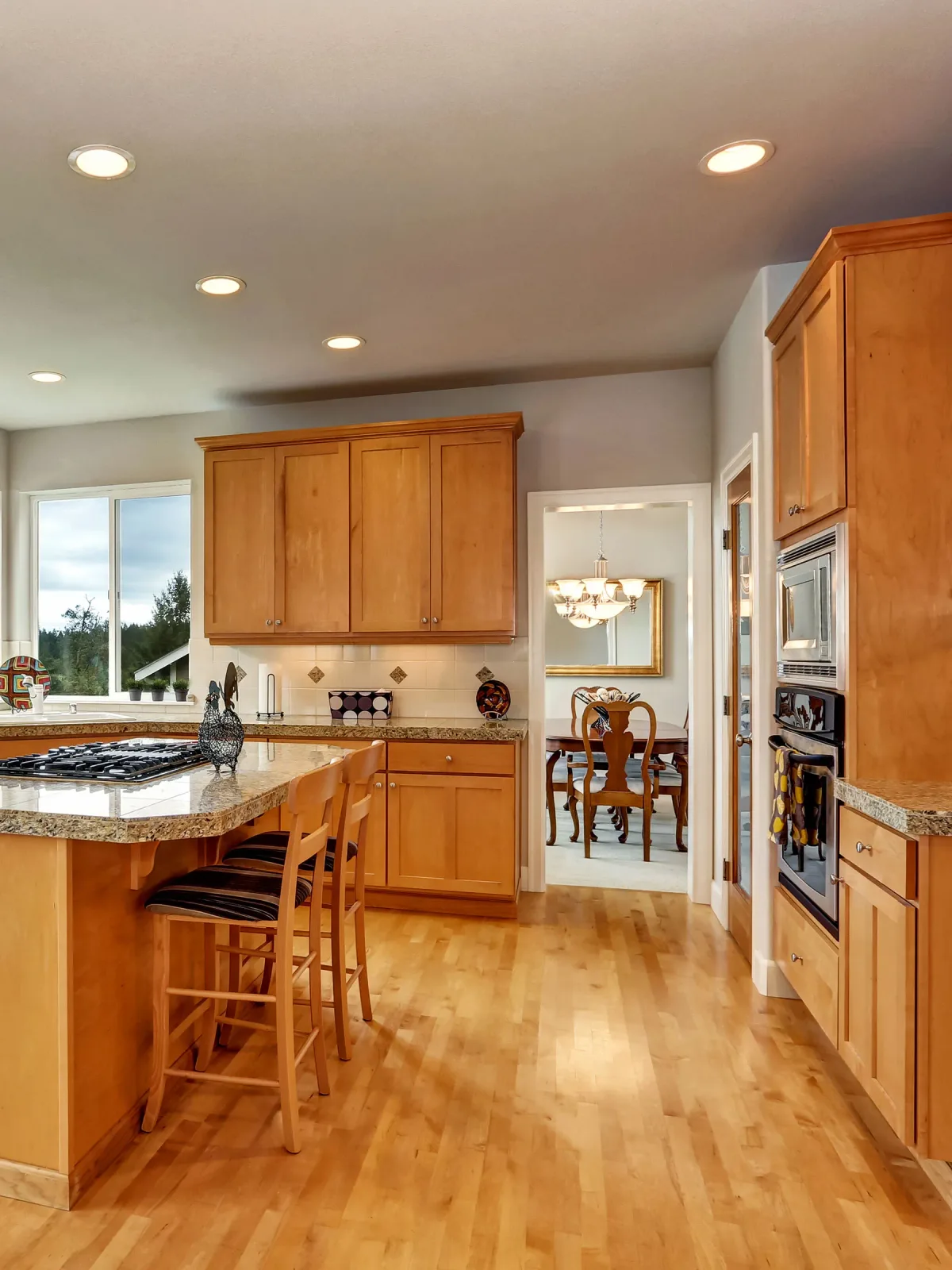 Honey-toned oak kitchen before refinishing