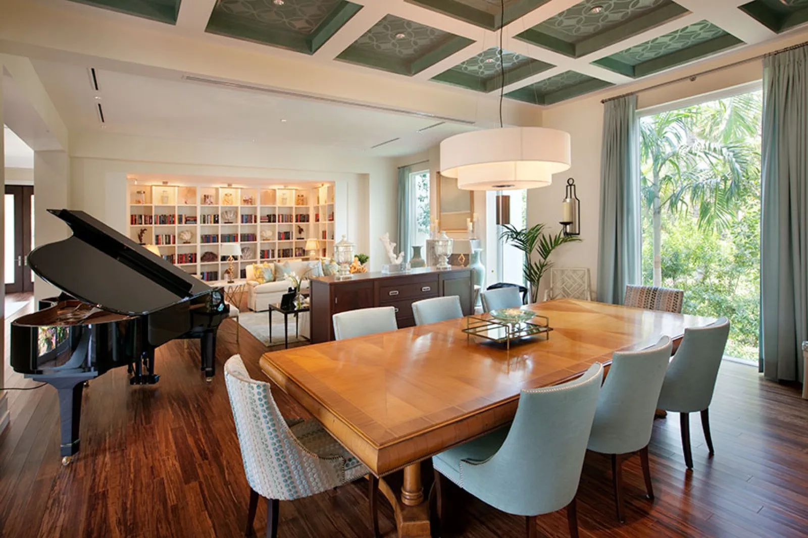 Dining room beneath a green coffered ceiling